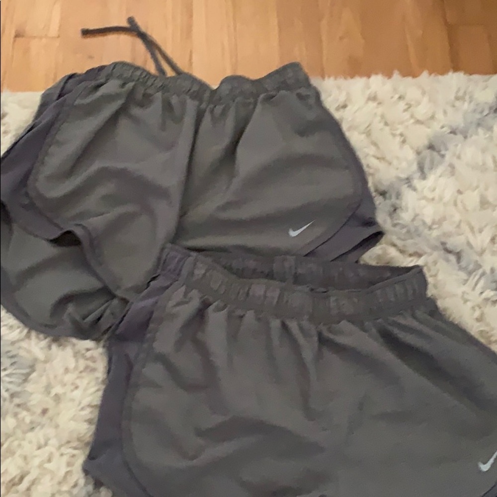 Two pairs of grey Nike running shorts
